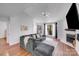 Spacious living room featuring hardwood floors, a ceiling fan, and lots of natural light at 1606 Sharon W Rd, Charlotte, NC 28210