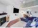 Bright living room features an open floor plan, fireplace, and hardwood floors at 1606 Sharon W Rd, Charlotte, NC 28210