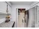 View of pantry area with adjacent stainless steel refrigerator and granite countertop at 1606 Sharon W Rd, Charlotte, NC 28210