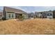 Large backyard featuring a pool, patio, and well-maintained landscaping with a view of other houses at 1638 Sweetmoss Loop, Denver, NC 28037