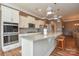 Modern kitchen with stainless steel appliances, granite countertops and a breakfast bar with stylish pendant lighting at 1638 Sweetmoss Loop, Denver, NC 28037