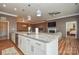 Open kitchen with granite counters, stainless steel appliances, and pendant lighting with a view of the living room at 1638 Sweetmoss Loop, Denver, NC 28037