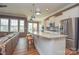 Beautiful kitchen with gray walls, white cabinets, granite countertops, stainless appliances and wood-look laminate floors at 1638 Sweetmoss Loop, Denver, NC 28037