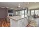 Beautiful kitchen with gray walls, white cabinets, granite countertops, stainless appliances and wood-look laminate floors at 1638 Sweetmoss Loop, Denver, NC 28037