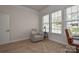 Bright home office with large windows, neutral walls, and comfortable seating with a side table at 1638 Sweetmoss Loop, Denver, NC 28037
