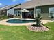 Backyard features a private in-ground pool, lush green lawn, and lounge seating at 1638 Sweetmoss Loop, Denver, NC 28037