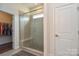 Bathroom shower with glass enclosure, built-in bench, and tiled walls with easy access to walk-in closet at 1638 Sweetmoss Loop, Denver, NC 28037