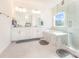 Luxurious bathroom featuring a double vanity, soaking tub, and a glass-enclosed shower with marble accents at 165 Winterberry St, Mooresville, NC 28117