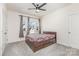 Relaxing bedroom featuring carpet, a ceiling fan, and a bed set with windows at 165 Winterberry St, Mooresville, NC 28117