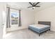 Modern bedroom features carpet, a ceiling fan, and a bed beneath a window at 165 Winterberry St, Mooresville, NC 28117