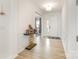 Inviting foyer with light wood flooring, a modern console table, and paneled walls at 165 Winterberry St, Mooresville, NC 28117