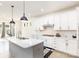 Modern kitchen with white cabinetry, quartz countertops, and stainless steel appliances at 165 Winterberry St, Mooresville, NC 28117
