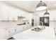 Bright, modern kitchen with white cabinets, stainless steel appliances, and quartz countertops at 165 Winterberry St, Mooresville, NC 28117