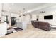Spacious living area featuring a kitchen island, modern furniture, and an open floor plan at 165 Winterberry St, Mooresville, NC 28117