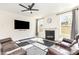 Spacious living room featuring a fireplace, large windows, and comfortable seating at 165 Winterberry St, Mooresville, NC 28117
