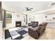 Open-concept living area with a fireplace, leather seating, and a view of the kitchen at 165 Winterberry St, Mooresville, NC 28117