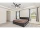 Spacious main bedroom with a tray ceiling, ceiling fan, plush carpet, and dual windows at 165 Winterberry St, Mooresville, NC 28117