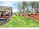 Spacious backyard featuring a screened porch, lush lawn, and a white picket fence at 1674 Wakefield Way, Rock Hill, SC 29730