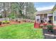 Well-maintained backyard featuring a lush lawn, white fence, and a charming screened-in porch at 1674 Wakefield Way, Rock Hill, SC 29730