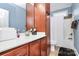 Bathroom featuring cherry cabinets, a white countertop, and a shower-tub combo at 1674 Wakefield Way, Rock Hill, SC 29730