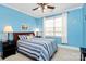 Cozy bedroom with blue walls, a ceiling fan, neutral carpet and a bed with striped bedding at 1674 Wakefield Way, Rock Hill, SC 29730