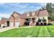 Charming two-story home with a brick and siding facade, three-car garage, and manicured lawn at 1674 Wakefield Way, Rock Hill, SC 29730