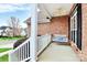 Relaxing front porch with a swing, brick facade, and a view of the neighborhood at 1674 Wakefield Way, Rock Hill, SC 29730