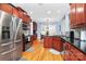 Well-lit kitchen with stainless steel appliances, ample cabinet space, hardwood floors, and adjacent dining area at 1674 Wakefield Way, Rock Hill, SC 29730