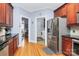 An elegant kitchen with cherry cabinets, stainless steel appliances, and hardwood floors leads to the laundry room at 1674 Wakefield Way, Rock Hill, SC 29730