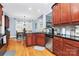 Well-lit kitchen featuring wooden cabinets, stainless steel appliances, granite counters, and breakfast nook at 1674 Wakefield Way, Rock Hill, SC 29730