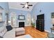 Bright living room with fireplace, hardwood floors, large windows, and high ceilings with convenient flow to the kitchen at 1674 Wakefield Way, Rock Hill, SC 29730