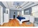 Bright main bedroom features tray ceilings, hardwood floors, and dresser at 1674 Wakefield Way, Rock Hill, SC 29730