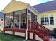 A home's enclosed sunroom with red stairs and hanging plants at 1674 Wakefield Way, Rock Hill, SC 29730