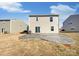 A serene backyard featuring a stamped concrete patio and grassy lawn, perfect for outdoor entertaining at 174 Hanging Rock Trl # 104, Statesville, NC 28625