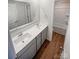 Well-lit bathroom with double sink vanity and a tub with shower at 174 Hanging Rock Trl # 104, Statesville, NC 28625