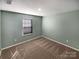 Bright bedroom with a window allowing natural light and neutral carpet at 174 Hanging Rock Trl # 104, Statesville, NC 28625