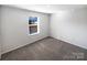 Simple bedroom with neutral carpeting and a window for natural light at 174 Hanging Rock Trl # 104, Statesville, NC 28625