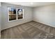 Bright bedroom with a window allowing natural light and neutral carpet at 174 Hanging Rock Trl # 104, Statesville, NC 28625