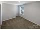 Cozy bedroom with neutral walls, carpet and a window with blinds at 174 Hanging Rock Trl # 104, Statesville, NC 28625
