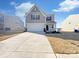 Charming two-story home with a two-car garage and a well-manicured front yard at 174 Hanging Rock Trl # 104, Statesville, NC 28625
