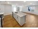Open-concept kitchen with an island featuring a sink and stainless steel appliances at 174 Hanging Rock Trl # 104, Statesville, NC 28625