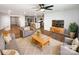 Sun-filled open concept living room showcasing modern furnishings, a ceiling fan, and seamless access to the kitchen at 174 Hanging Rock Trl # 104, Statesville, NC 28625