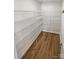 Walk-in pantry featuring sturdy shelving, providing ample storage space at 174 Hanging Rock Trl # 104, Statesville, NC 28625