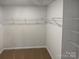 Spacious walk-in closet features neutral walls, shelving, and carpeted floor at 174 Hanging Rock Trl # 104, Statesville, NC 28625