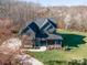 An aerial view of a beautiful gray two-story home on a large lot with mature trees at 180 Twin Sisters Ln, Mooresville, NC 28117