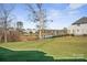 Expansive backyard with lush green lawn and views of the lake and surrounding homes at 180 Twin Sisters Ln, Mooresville, NC 28117