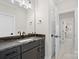 Updated bathroom has granite countertop, dark cabinets, and tile floors at 180 Twin Sisters Ln, Mooresville, NC 28117