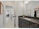 Modern bathroom with granite countertop, dark cabinets, and a large mirror at 180 Twin Sisters Ln, Mooresville, NC 28117