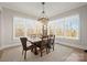 Sunlit dining room with large windows and modern chandelier at 180 Twin Sisters Ln, Mooresville, NC 28117