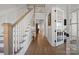 Elegant foyer with hardwood floors, staircase, and view of the living spaces at 180 Twin Sisters Ln, Mooresville, NC 28117